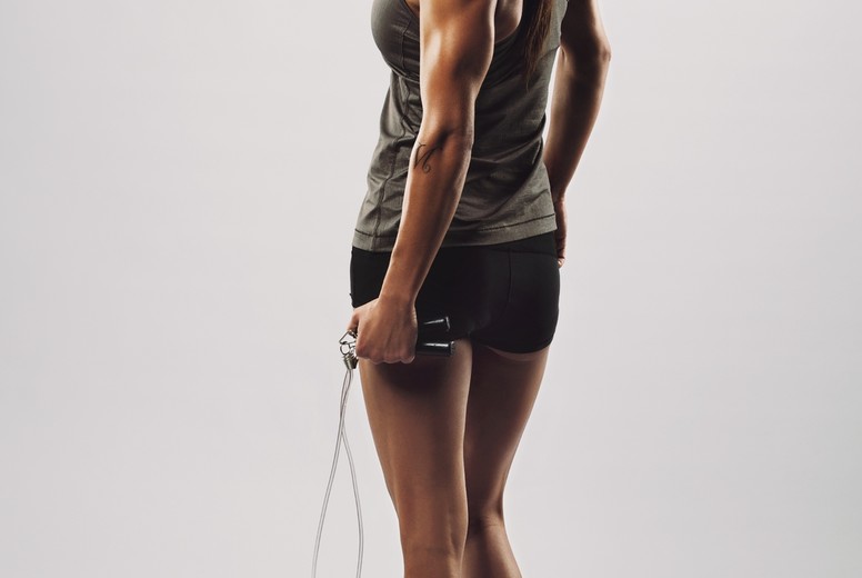 Fitness woman posing with skipping rope