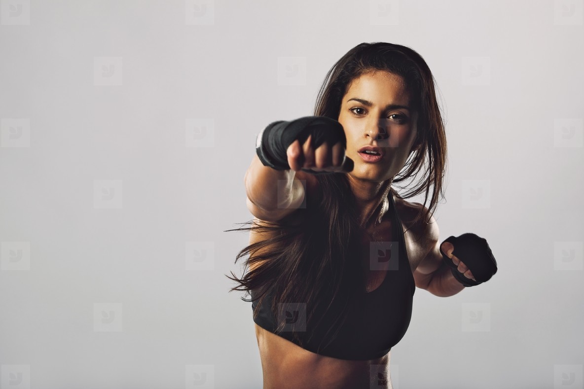 Female boxer throwing a punch in front