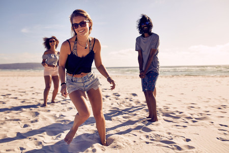 Beautiful woman enjoying on the beach with friends