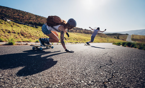 Young people skateboarding outdoors on the road