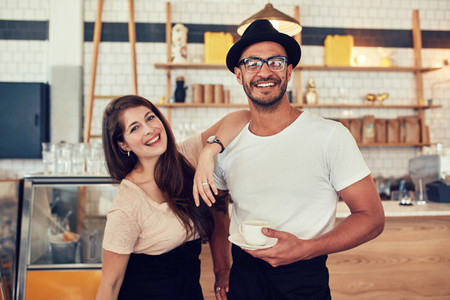 Young man and woman at cafe with a cup of coffee