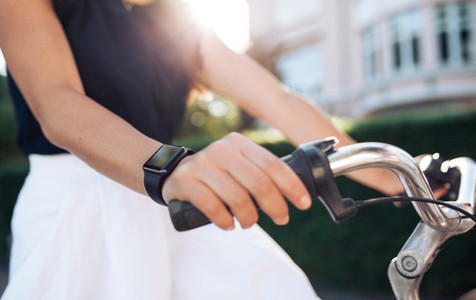 Woman riding bike with a smartwatch
