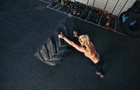Fit young woman doing crossfit exercise