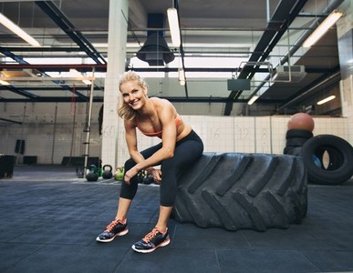 Female athlete taking rest after tough crossfit workout
