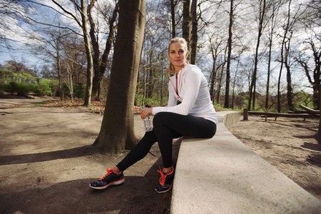 Female runner taking a rest from training in nature
