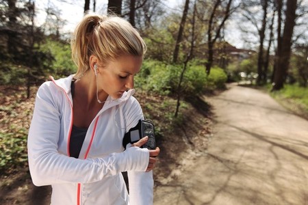 Female runner monitor her progress on smartphone