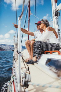 Mature couple traveling by a boat