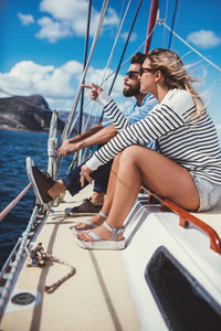 Young couple sitting together on a yacht