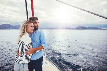 Young couple enjoying the view from a sailboat