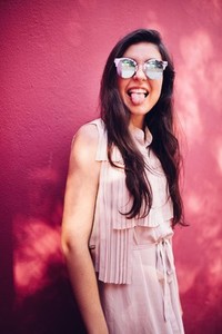 Happy young woman stretching out her tongue