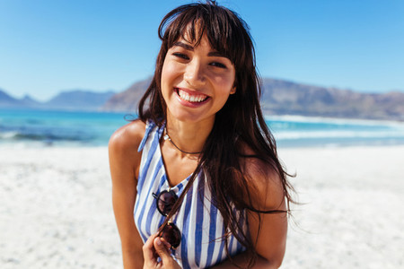 Young woman on the beach with beautiful smile