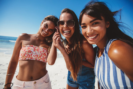 Three young women friends on beach