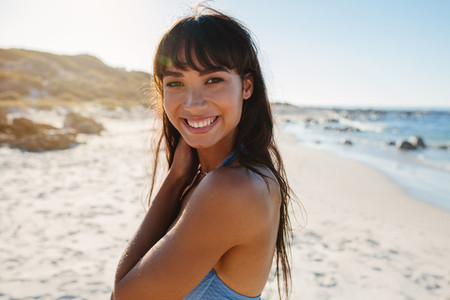 Smiling young woman in bikini on the beach