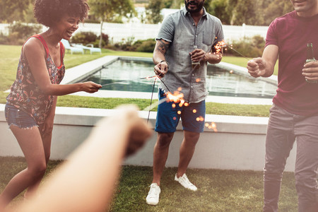 Young people playing with sparklers