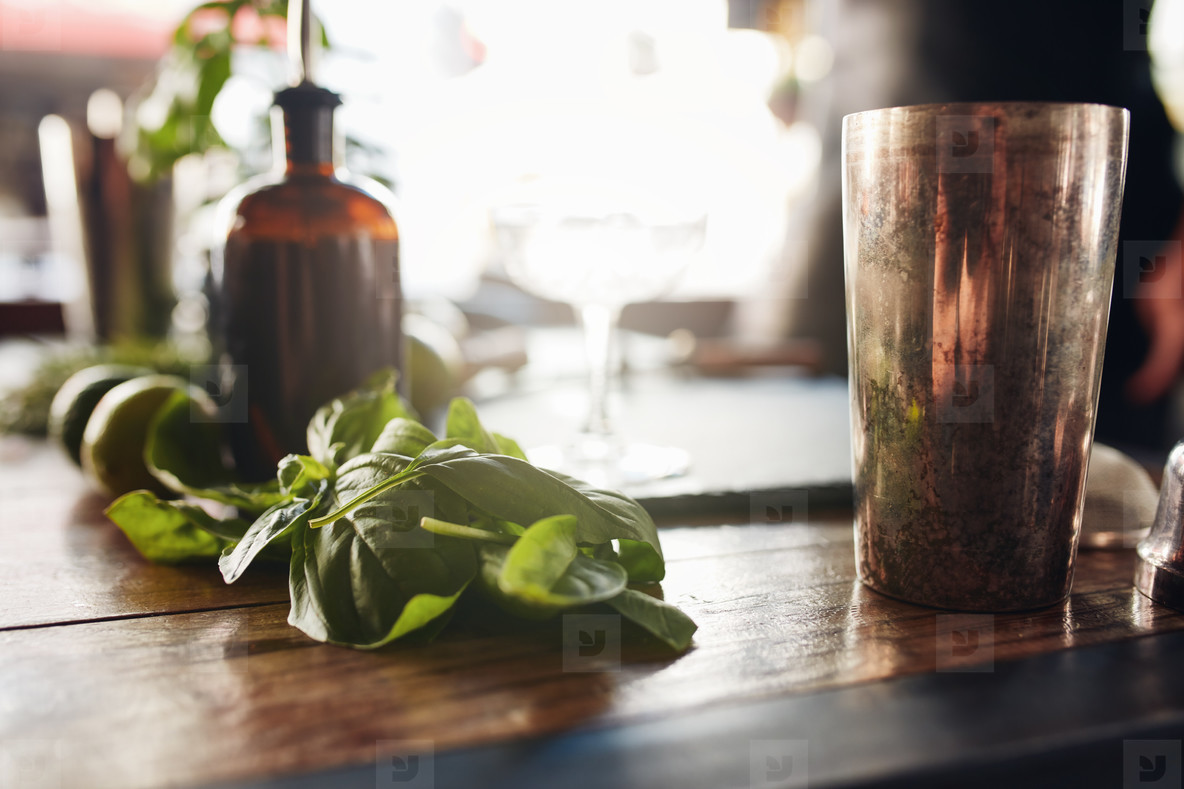 Basil leaves with cocktail shaker
