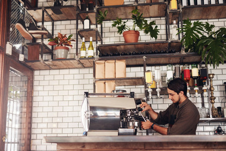 Male barista making a cup of coffee