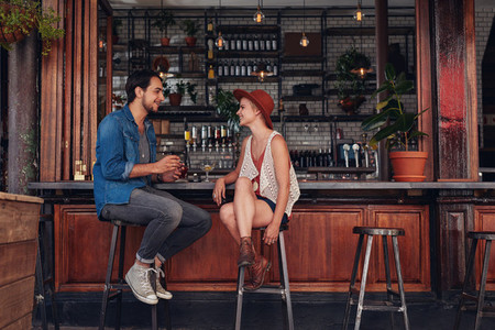 Young couple sitting at cafe counter