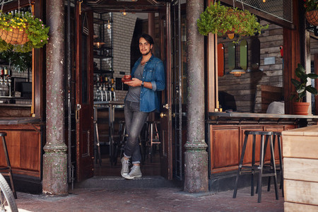 Stylish young man at a cafe entrance