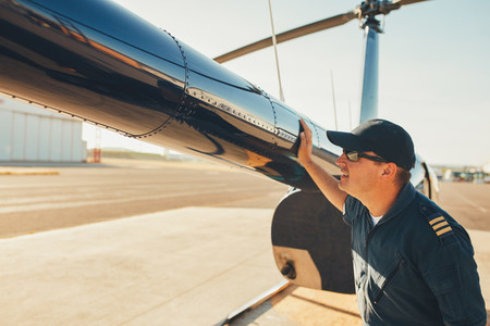 Mechanic checking helicopter before take off