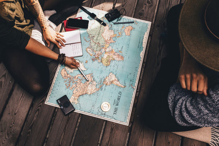 Couple planning vacation using the world map
