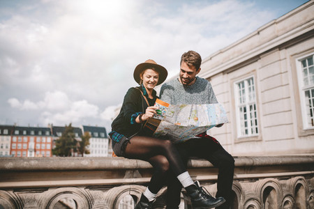 Young couple looking at a city map