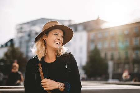 Smiling tourist woman wearing hat