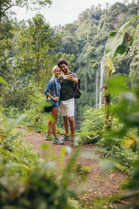 Loving young couple in forest taking self portrait
