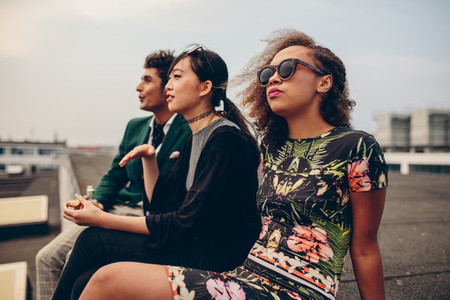 Young people sitting on rooftop