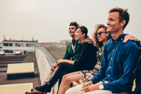 Friends sitting together on rooftop