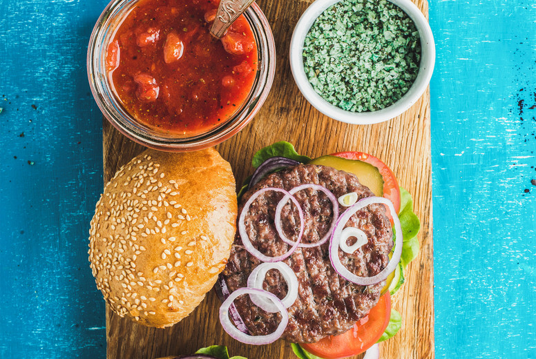 Homemade beef burgers with onion, fresh vegetables, spices, tomato sauce