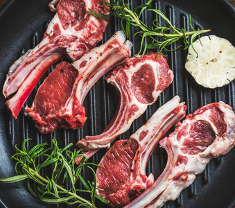Raw uncooked lamb meat chops with rosemary and garlic
