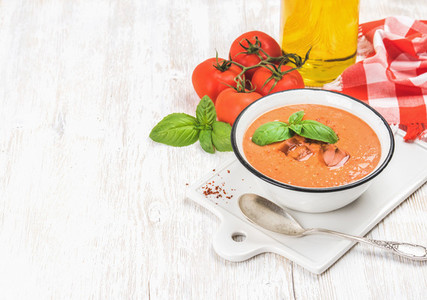 Cold gazpacho soup with ice basil and tomatoes copy space