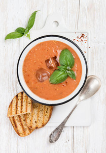 Cold gazpacho tomato soup in bowl with toasted bread