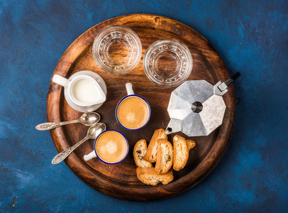 Coffee espresso cantucci cookies and milk on wooden serving board