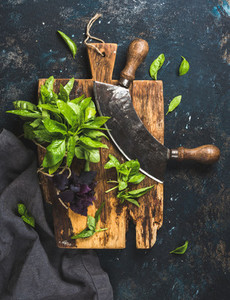 Fresh green and purple basil leaves with herb chopper knife