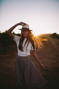 Countrygirl on farmland in sunset