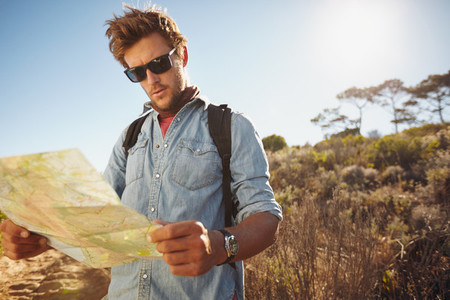 Handsome hiker using a map