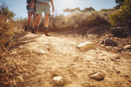 Two people hiking along a dirt trail