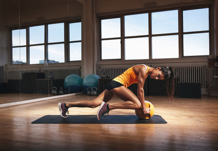 Muscular woman doing intense core workout