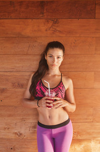 Sporty woman with glass of fresh fruit juice