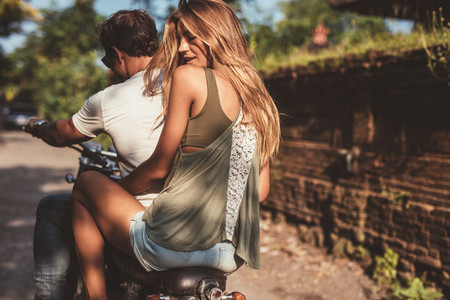 Attractive female with her boyfriend on motorcycle