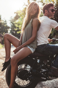 Couple outdoors on motorbike