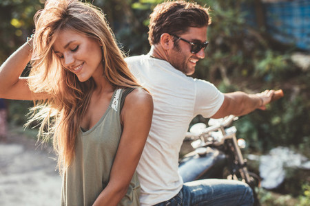 Beautiful young couple on a motorcycle