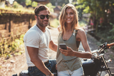 Happy young couple with motorcycle