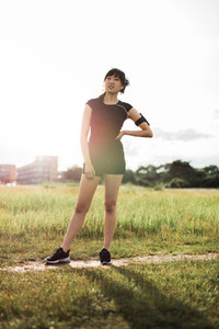 Woman runner in park ready for morning exercise
