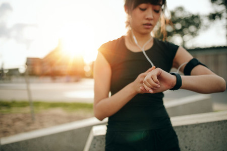 Fitness female checking her performance on smartwatch