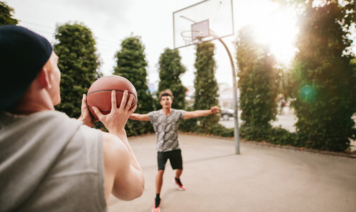 Streetball players on court playing basketball