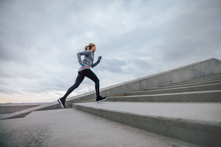 Woman running on steps outdoors