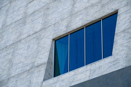 Blue window on a big gray facade