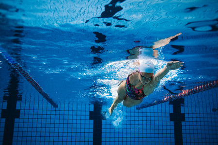 Underwater shot of female swimmer in action